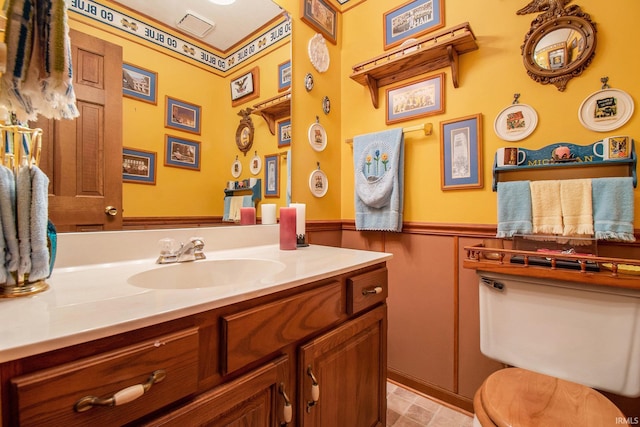 bathroom featuring vanity, tile patterned floors, and toilet