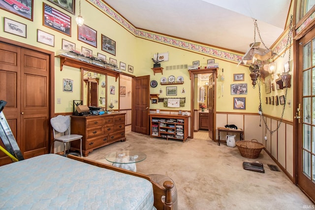 bedroom with light carpet and vaulted ceiling