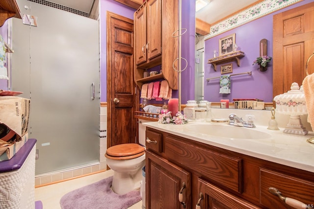 bathroom with walk in shower, vanity, and toilet