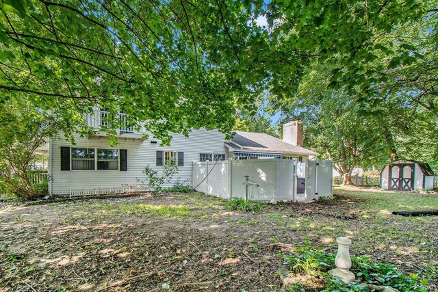 rear view of property with a shed