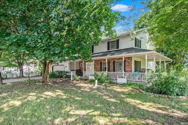 view of front facade with covered porch and a front lawn