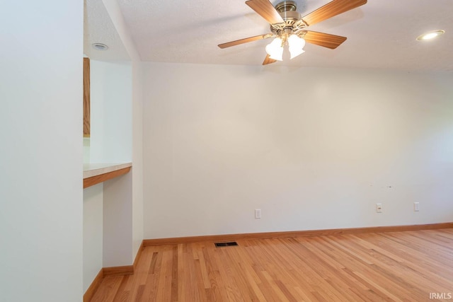 unfurnished room with ceiling fan and light hardwood / wood-style floors