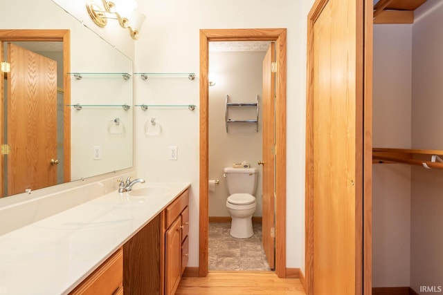 bathroom with vanity, hardwood / wood-style floors, and toilet