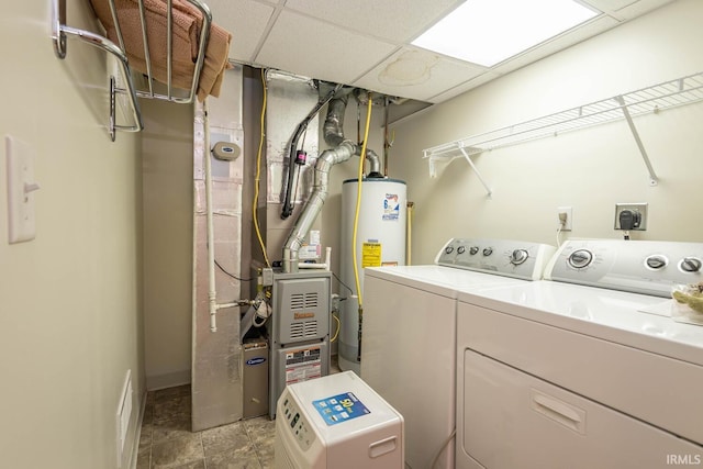 laundry area featuring washing machine and dryer and water heater