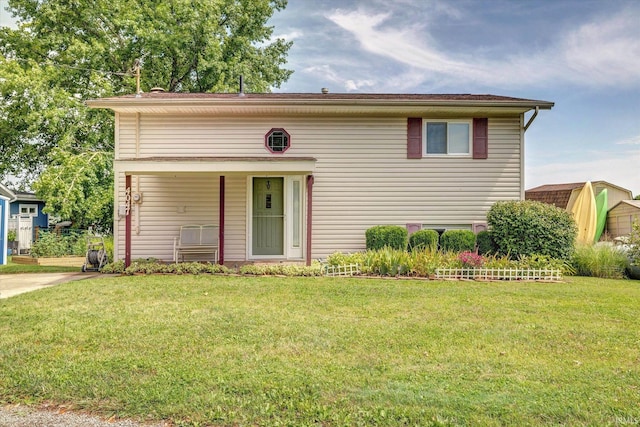 view of front of home featuring a storage shed and a front yard