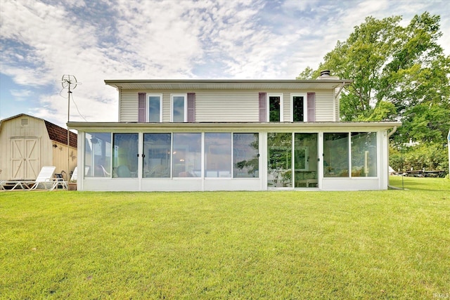 rear view of property featuring a lawn and a sunroom