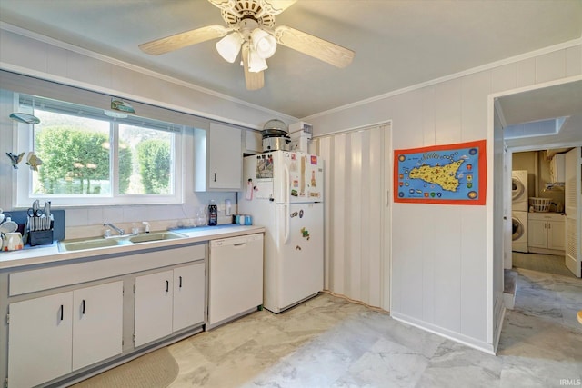 kitchen featuring white appliances, washer / dryer, sink, and white cabinets