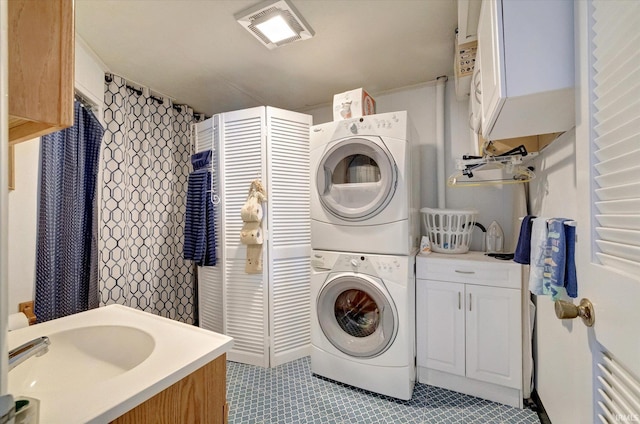 laundry room featuring stacked washer / drying machine