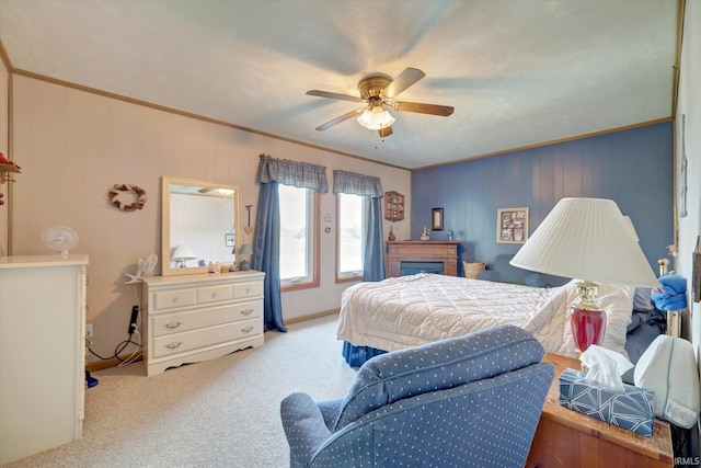 carpeted bedroom featuring ceiling fan and ornamental molding