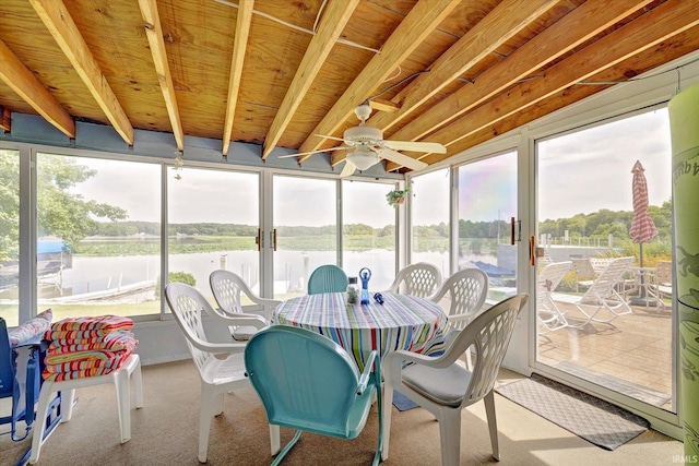 sunroom / solarium featuring a water view and ceiling fan