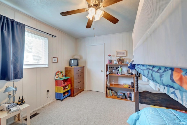 bedroom featuring ceiling fan and light carpet