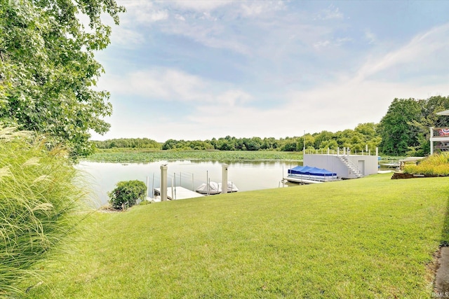 view of yard with a water view and a boat dock