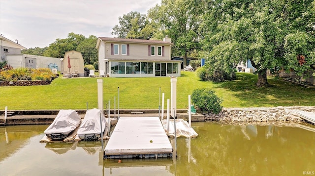 dock area featuring a yard and a water view