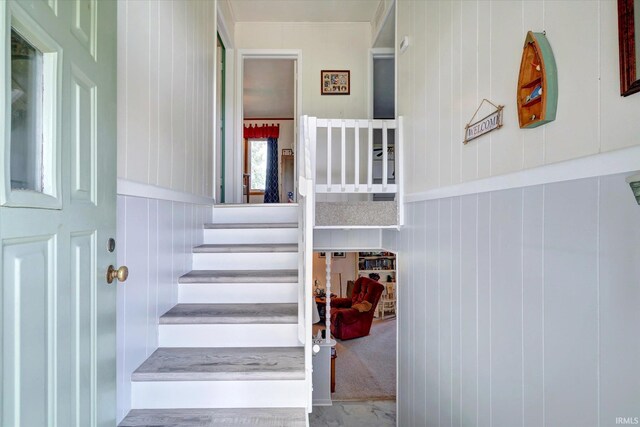 living room featuring carpet, a fireplace, and crown molding