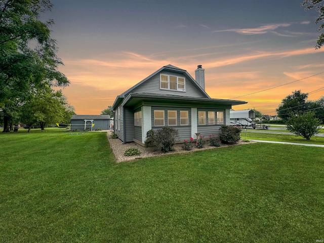 bungalow-style home with a yard