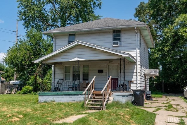 view of front of property with a porch and a front lawn