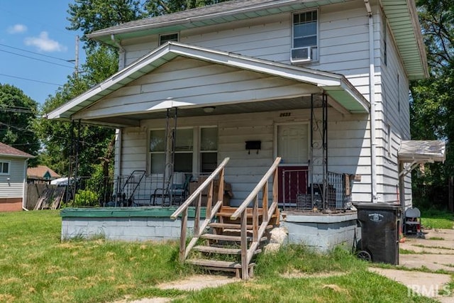 bungalow featuring a porch and cooling unit