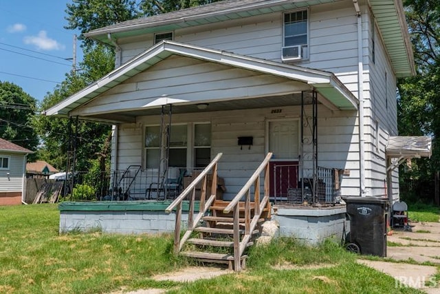 traditional style home with a front yard and covered porch