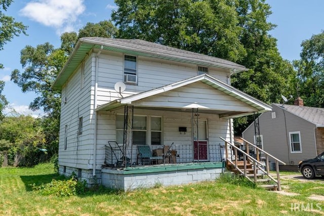 view of front facade featuring covered porch and a front lawn