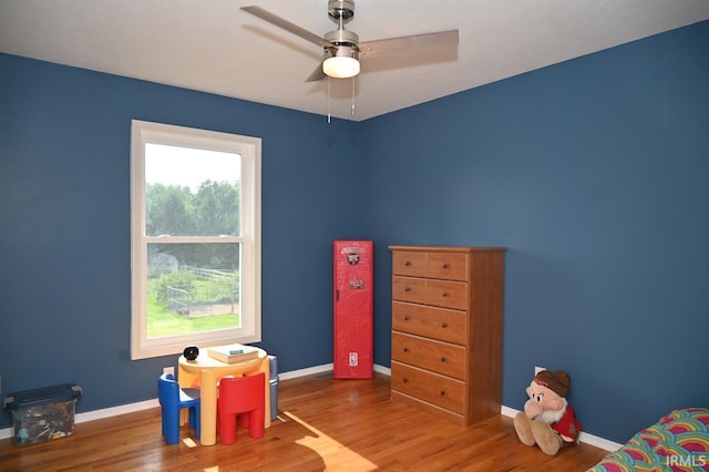 playroom with ceiling fan and wood-type flooring