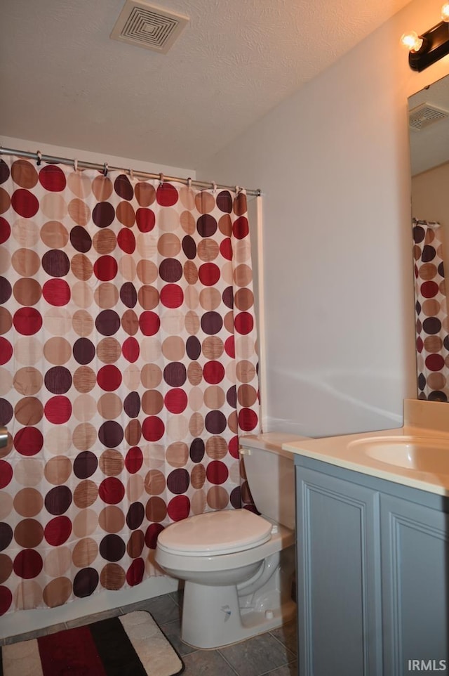 bathroom with vanity, tile patterned floors, and toilet