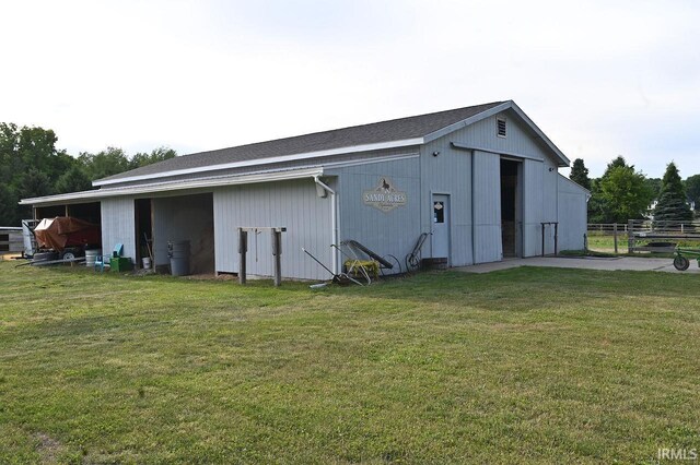 view of outbuilding with a lawn