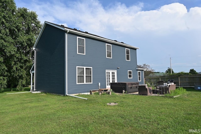 back of property featuring an outdoor living space, a lawn, and a patio area