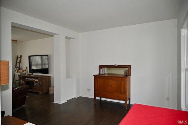 bedroom with dark wood-type flooring