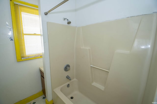 bathroom featuring a healthy amount of sunlight, vanity, and shower / tub combination