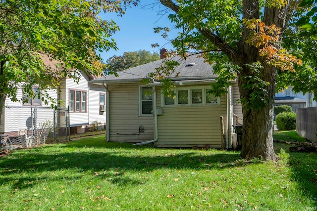 rear view of house with a lawn