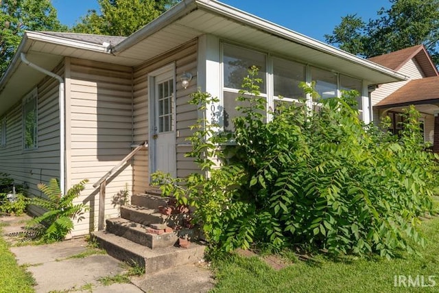 view of home's exterior with a sunroom