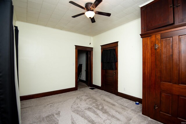 unfurnished bedroom featuring ceiling fan and light carpet