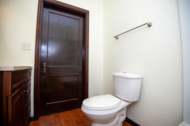 bathroom featuring vanity, hardwood / wood-style floors, and toilet