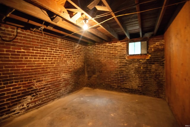 basement featuring brick wall