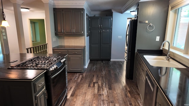 kitchen with decorative light fixtures, black appliances, ornamental molding, sink, and dark hardwood / wood-style floors