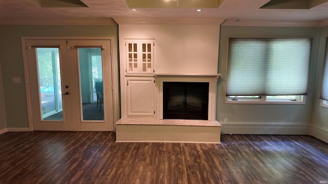 unfurnished living room with a wealth of natural light, french doors, crown molding, and dark wood-type flooring