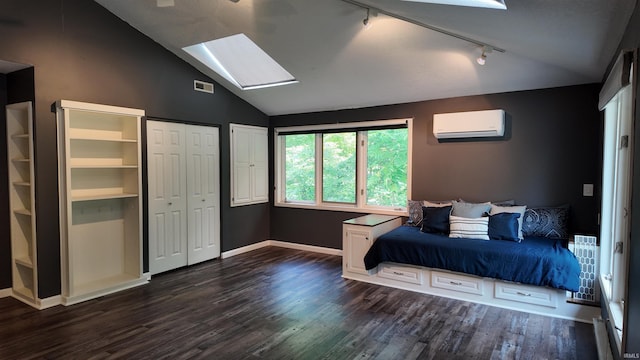 bedroom featuring a wall unit AC, vaulted ceiling with skylight, rail lighting, and dark wood-type flooring