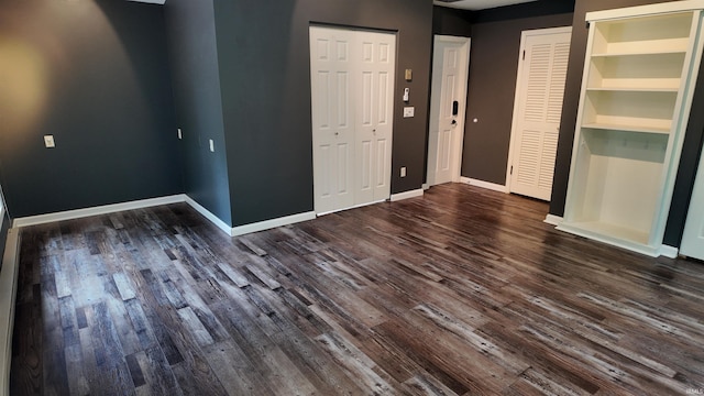 interior space featuring dark wood-type flooring and built in shelves