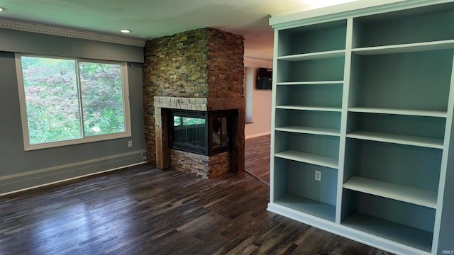 unfurnished living room featuring brick wall, dark hardwood / wood-style flooring, and a fireplace