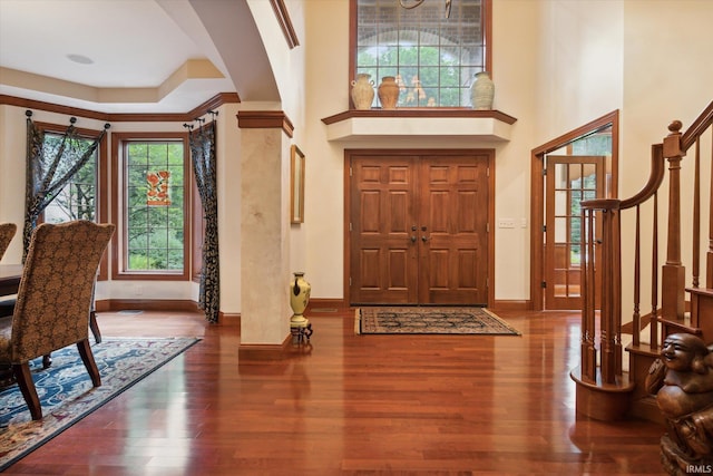 entrance foyer featuring stairs, baseboards, and wood finished floors