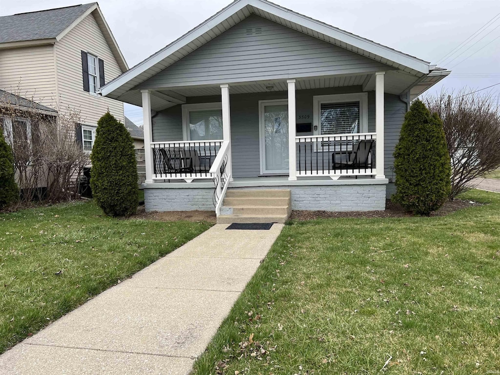 bungalow with a porch and a front yard