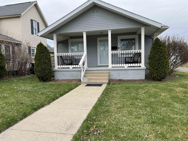 bungalow with a porch and a front yard