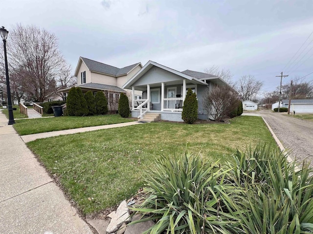 view of front of house featuring covered porch and a front yard