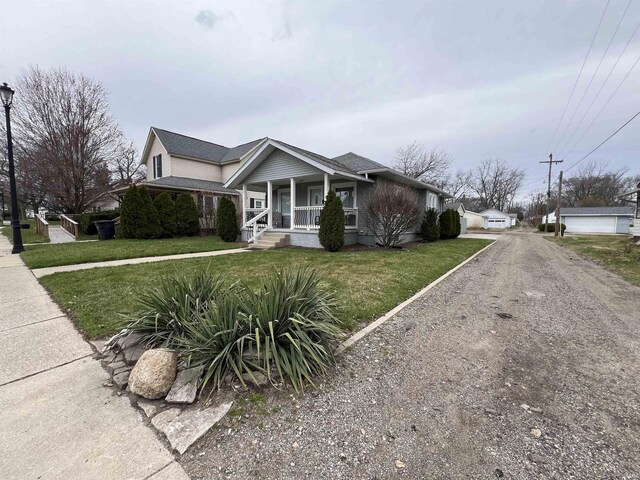 view of front of home featuring covered porch and a front yard