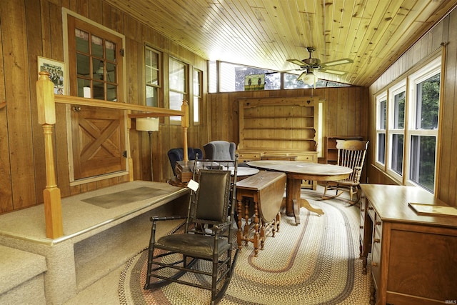 sunroom / solarium featuring a ceiling fan, wooden ceiling, and vaulted ceiling