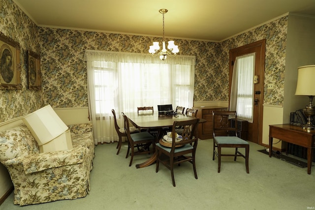 dining room with crown molding, wainscoting, and wallpapered walls