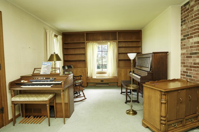 interior space with built in features, light colored carpet, brick wall, and ornamental molding