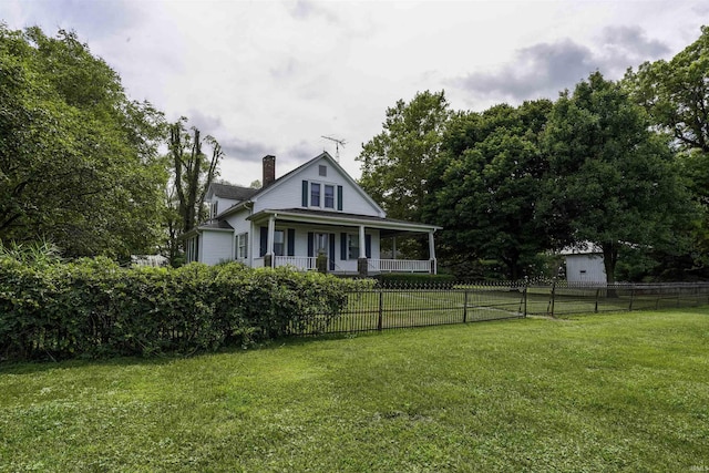 view of front of home featuring a fenced front yard, a chimney, a porch, and a front yard