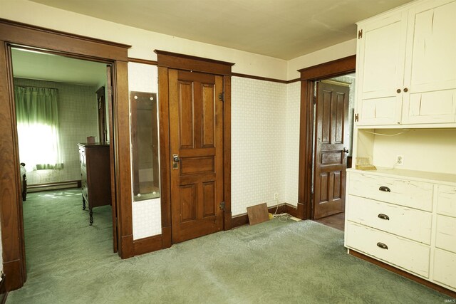 bedroom with carpet and baseboard heating