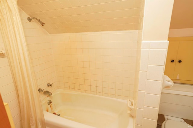 bathroom featuring shower / tub combo, tile walls, and toilet